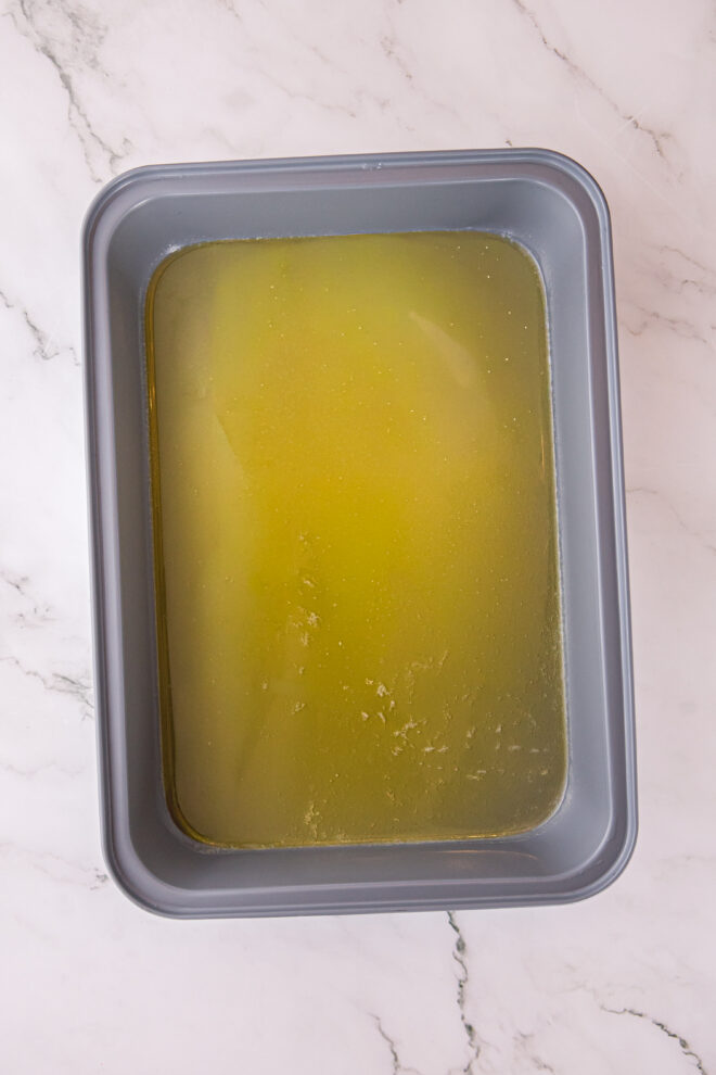 melted butter in the bottom of a 9x13 baking pan