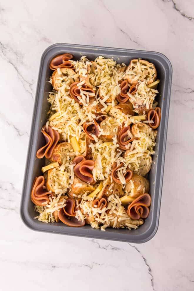 Mozzarella cheese sprinkled over ham and cheese casserole before baking
